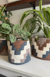 Geometric crochet baskets with potted plants inside. thumbnail