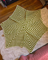 Full view of hexagonal crochet afghan, worked in granny stitch in cream and chartreuse green. thumbnail
