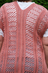 Back view of a lacy cardigan, showing back seam and alternating lace and semi-solid sections. thumbnail