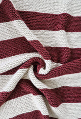 Close up of garter stitch blanket in large stripes of cream and merlot. thumbnail