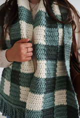 Close up of scarf being worn, showing large scale gingham design. thumbnail