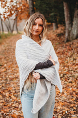 Woman with a grey shawl, standing outside in leaves thumbnail