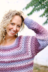 Close up of raglan shaping and sleeve of purple & pink crochet sweater. thumbnail
