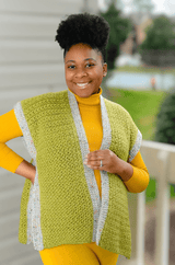 Woman in yellow dress wears an open vest in apple green with grey tweed borders.  thumbnail
