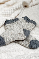 Chunky socks laying on cream blanket.  thumbnail