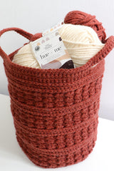 Top view of crochet basket holding skeins of yarn.  thumbnail