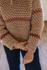 Close up of lower part of sweater, showing ribbed hems and cuffs.  thumbnail