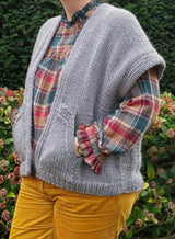 Close front view of cardigan vest, showing drop shoulder style, rib details, and front pocket.  thumbnail