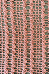 Close up view of open grid pattern on blanket with vertical cables. blanket is stretched open.  thumbnail