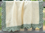 Full view of blanket draped over back of wooden bench. Blanket is shown in baby size.  thumbnail