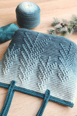 Close up of tote bag showing pine tree stitch pattern on horizontal textured background.  thumbnail