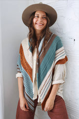 Cropped front view of large triangular crochet shawl draped over shoulders, with points hanging below waist. thumbnail