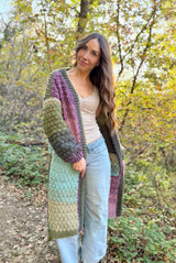 Front view of woman wearing long crochet cardigan or duster. It is open in the front, with a front band. thumbnail