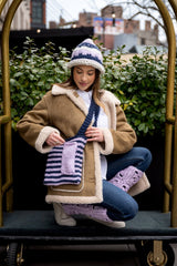 Model wearing knit had and bag with crochet leggings thumbnail
