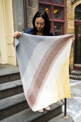 Woman holding multicolor blanket up thumbnail
