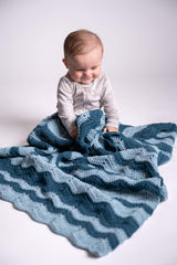 Baby with crochet ripple blanket in contrasting blue tones thumbnail