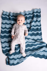 Baby laying on crochet ripple blanket in contrasting blue tones thumbnail