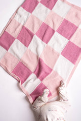 Knit gingham blanket in pink and white with baby  thumbnail