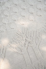close up of the off white tree of life blanket with intricate tree design thumbnail